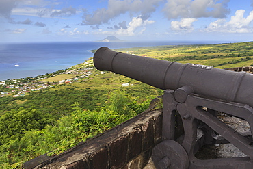 Cannon points towards the sea, with St. Eustatius in the distance, Brimstone Hill Fortress, UNESCO World Heritage Site, St. Kitts, St. Kitts and Nevis, West Indies, Caribbean, Central America