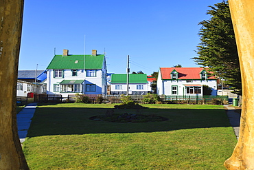 Christ Church cathedral green and houses, seen through whale bone arch, Stanley, East Falkland, Falkland Islands, South America 