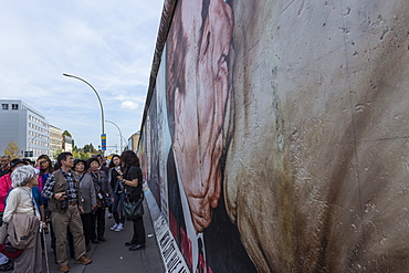 Tourists looking at mural My God, Help Me Survive Amid this Deadly Love by Dimitry Vrubel, Berlin Wall, East Side Gallery, Berlin, Germany, Europe