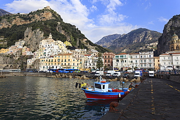 Fisherman in fishing boat and Amalfi town, Costiera Amalfitana (Amalfi Coast), UNESCO World Heritage Site, Campania, Italy, Europe