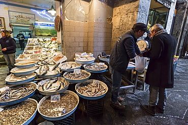 Man buys fish at fish shop, Historic Centre (Centro Storico), UNESCO World Heritage Site, Naples, Campania, Italy, Europe