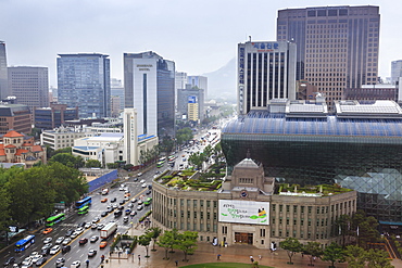 Elevated view over new City Hall, modern glass and steel building on Seoul Plaza, on a rainy summer day, Seoul, South Korea, Asia