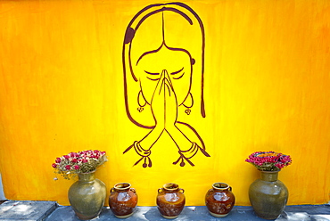 Drawing of praying woman on a yellow wall in Lijiang, Yunnan, China, Asia