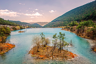 Small island with trees at Baishuihe, White Water River in Yunnan, China, Asia