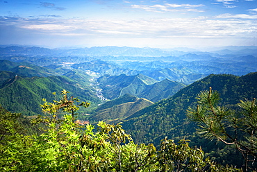 Misty mountain chains and valley with village as seen from Tian Mu Shan peak, Zhejiang, China, Asia