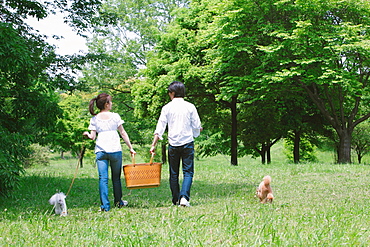 Couple Walking with Pets in Park