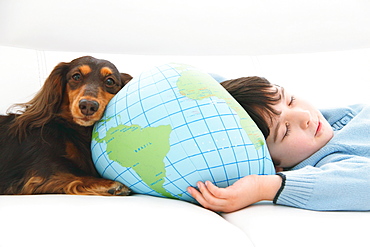 Boy and dog lying down on the couch