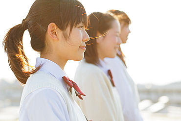 Portrait of Japanese schoolgirls in their uniforms looking away