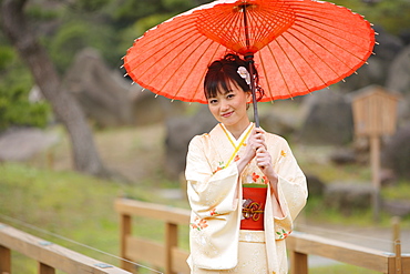 Woman Dressed in Kimono Standing Holding Parasol