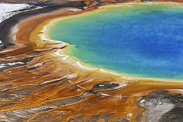 Grand Prismatic Spring, a bright turquoise pool and site of geothermal activity, with mineral rich deposits at the edge, Grand Prismatic Spring, Yellowstone National Park, Wyoming