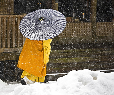 A Bhuddist monk walks through a snow flurry in Koyasan, a centre for Shingon Esoteric Buddhism, Koyasan, Osaka, Japan