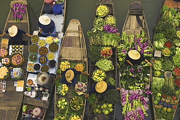 Aerial view of a floating market on a canal in Bangkok, local boats laden with fresh food, moored close together, Bangkok, Thailand, 