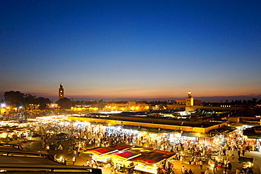 A few over the illuminated Djemaa el-Fna market square at sunset in Marrakesh, Morocco