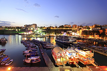 Boats moored in Old Town harbour at night in Antalya, Turkey