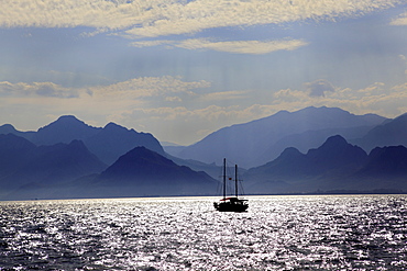 View of mountains and boat in sea at Antalya, Turkey