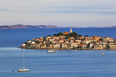 View of Primosten town and mountains on the horizon of Adriatic sea in Croatia