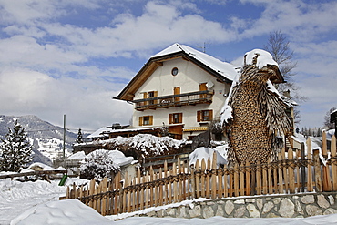 View of Restaurant Bear Cave surrounded with snow in winter, South Tyrol, Italy