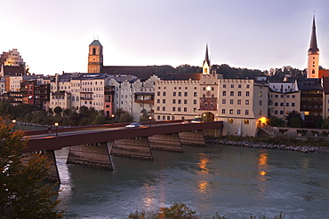 Woman walking on street in front of Wasserburg am Inn in Rosenheim, Bavaria, Germany