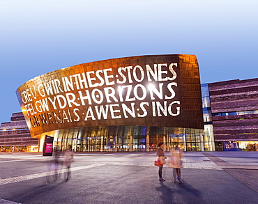 Illuminated exterior of Millennium centre in Cardiff at night, Wales, UK, blurred motion