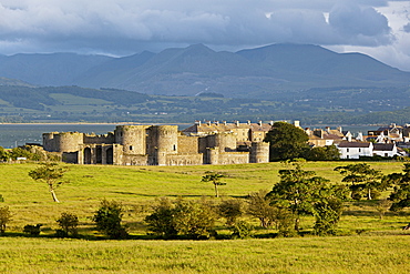 View of Beaumaris castle at Island of Anglesey with mountain ranges in background, Wales