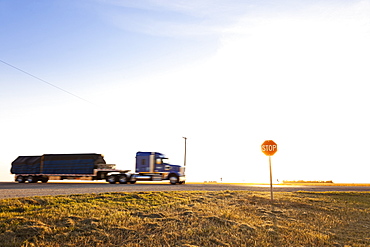 View of truck and stop sign board on highway, Saskatchewan, Canada