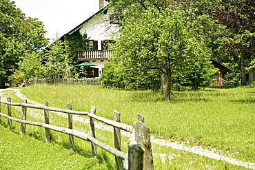 View of house with balcony and fence in garden