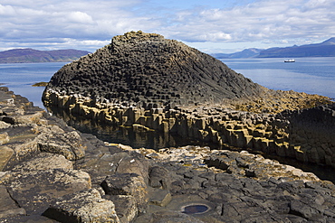 Basalt columns next to Fingal's Cave on the Isle of Staffa, with Mull in the background, Inner Hebrides, Scotland, United Kingdom, Europe