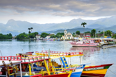 Fishing boats in Paraty village with the mountains of the Serra da Bocaina behind, Rio de Janeiro state, Brazil, South America 