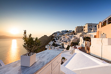 Sunset over the Aegean Sea seen from a terrace of the typical Greek village of Firostefani, Santorini, Cyclades, Greek Islands, Greece, Europe