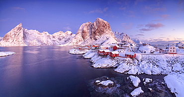 Panoramic view of snowy peaks and frozen sea at dawn around the fishing village, Hamnoy, Nordland, Lofoten Islands, Arctic, Norway, Scandinavia, Europe