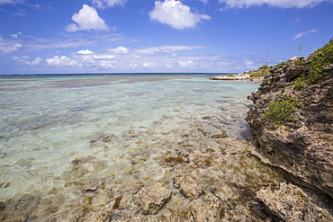 The turquoise shades of the Caribbean Sea seen from the cliffs of Green Island, Antigua and Barbuda, Leeward Islands, West Indies, Caribbean, Central America