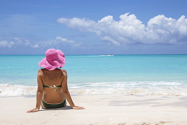 Lady on the sand surrounded by the turquoise Caribbean sea, Jolly Beach, Antigua, Antigua and Barbuda, Leeward Islands, West Indies, Caribbean, Central America