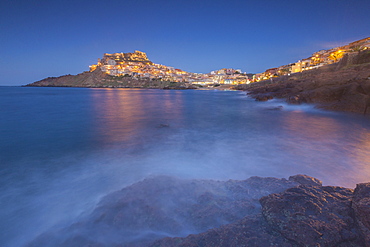 Waves frame the village perched on promontory at dusk, Castelsardo, Gulf of Asinara, Province of Sassari, Sardinia, Italy, Mediterranean, Europe