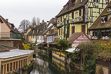 Colored houses reflected in river Lauch at Christmas time, Petite Venise, Colmar, Haut-Rhin department, Alsace, France, Europe