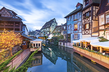 Dusk lights on houses reflected in River Lauch at Christmas, Petite Venise, Colmar, Haut-Rhin department, Alsace, France, Europe