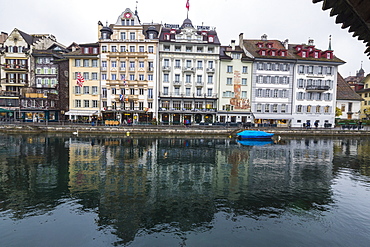 The typical buildings of the old medieval town are reflected in River Reuss, Lucerne, Switzerland, Europe