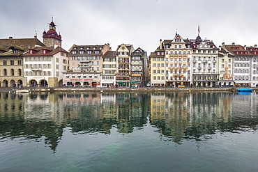 The typical buildings of the old medieval town are reflected in River Reuss, Lucerne, Switzerland, Europe