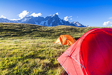 Camping tents in the green meadows with Mont De La Saxe in the background, Courmayeur, Aosta Valley, Italy, Europe