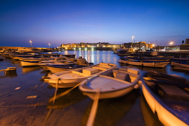 Dusk lights the harbor and the medieval old town of Gallipoli, Province of Lecce, Apulia, Italy, Europe