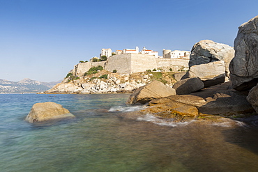 The old fortified citadel on the promontory surrounded by the clear sea, Calvi, Balagne Region, Corsica, France, Mediterranean, Europe