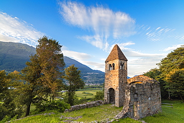 Sunset sky frames the ancient Abbey of San Pietro in Vallate, Piagno, Sondrio province, Lower Valtellina, Lombardy, Italy, Europe