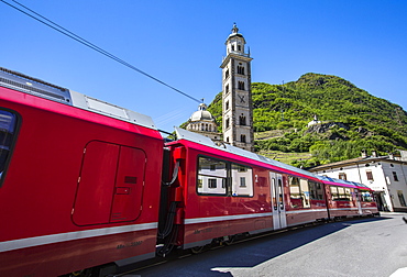 The Bernina Express train passes near the Sanctuary of Madonna di Tirano, not far from the Swiss border, on the UNESCO World Heritage Site railway, Lombardy, Italy, Europe