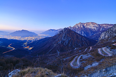 Dusk on the illuminated city of Lecco seen from the road to Morterone, Lombardy, Italy, Europe