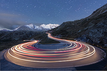 Star trail and lights of car traces, Bernina Pass, Poschiavo Valley, Engadine, Canton of Graubunden, Switzerland, Europe