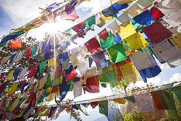 The Tibetan prayer flags made of colored cloth that are often hung on the top of the mountains to bless places, Bhutan, Asia