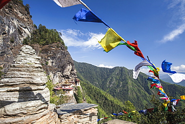 The colorful Tibetan prayer flags invite the faithful to visit the Taktsang Monastery, Paro, Bhutan, Asia