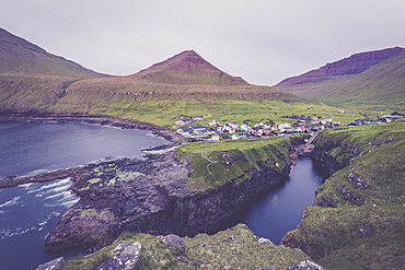 The village of Gjogv in between mountains and ocean, Eysturoy Island, Faroe Islands, Denmark, Europe