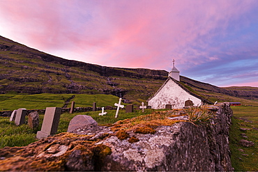 Pink sunset on church and cemetery, Saksun, Streymoy Island, Faroe Islands, Denmark, Europe