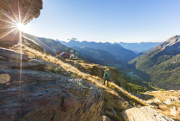 Hiker on path towards Rifugio Longoni, Chiesa in Valmalenco, Malenco Valley, province of Sondrio, Valtellina, Lombardy, ItalyHiker on path towards Rifugio Longoni, Chiesa in Valmalenco, Malenco Valley, province of Sondrio, Valtellina, Lombardy, Italy