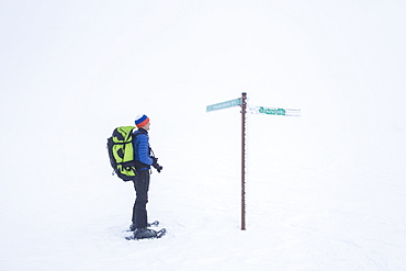 Photographer on snowshoes, Pallas-Yllastunturi National Park, Muonio, Lapland, Finland, Europe